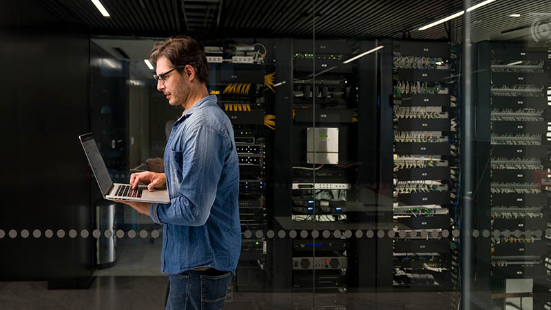 An employee working on the laptop inside the data center	