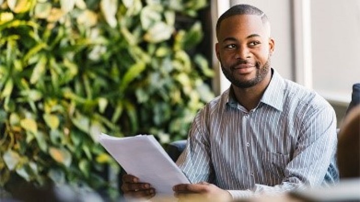  Employee holding the checklist of sustainability program