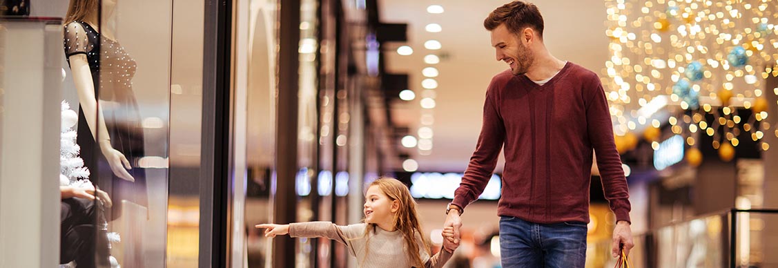 Father and daughter spending a day in shopping mall