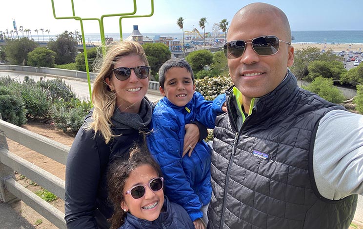 Drew family vacation to Santa Monica. Family is posing near the Santa Monica Pier.