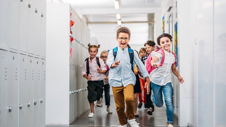 pupils running through school corridor