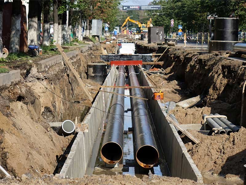 Replacement pipes in the city. Construction of heating mains for municipal infrastructure, the concept of city development.