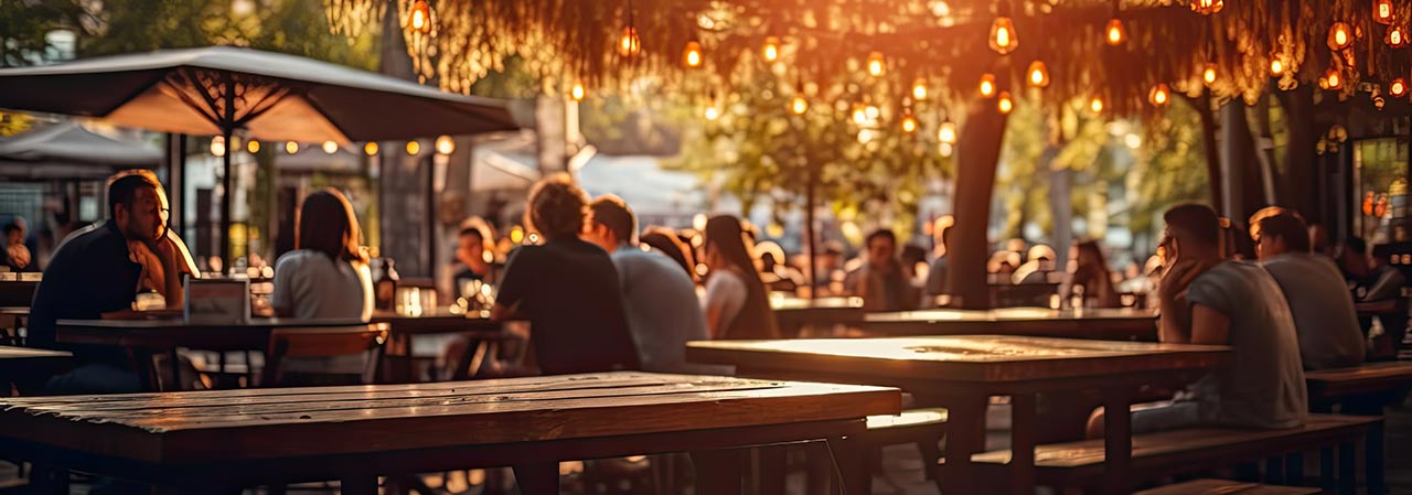 Bokeh background of street bar beer restaurant, outdoor. People sit chill out and hang out dinner and listen to music together in avenue