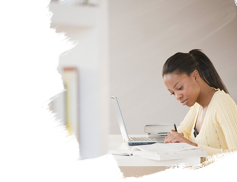Mixed race woman doing homework with laptop