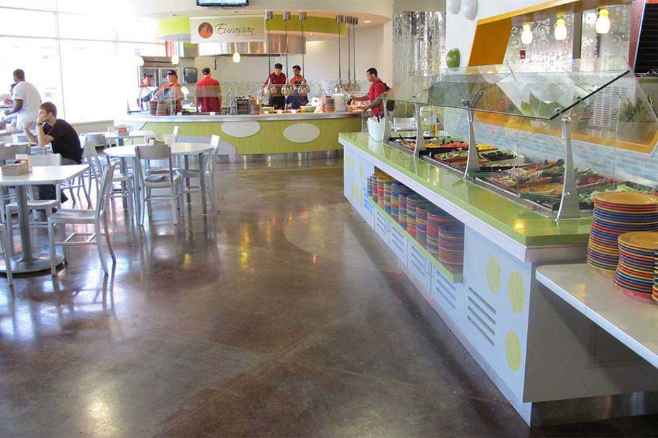 Interior view of a dining hall and kitchen area inside a university