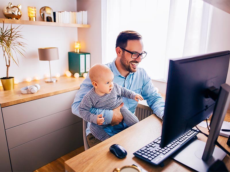 Dad working at home with baby