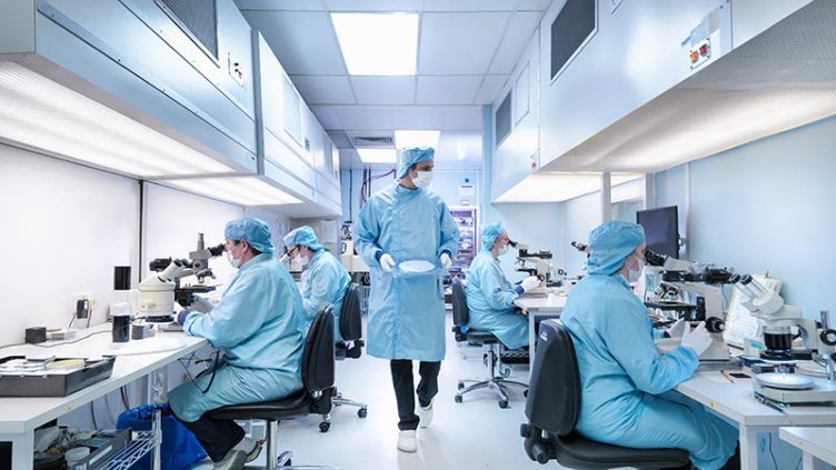 Clean room technicians and engineers test wafers and semiconductor materials