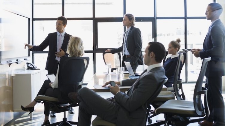 View of a meeting of employees in a real estate firm inside a meeting room