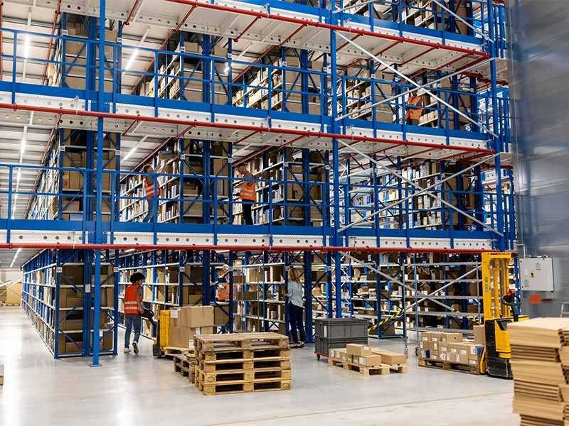 Large distribution warehouse with people working 