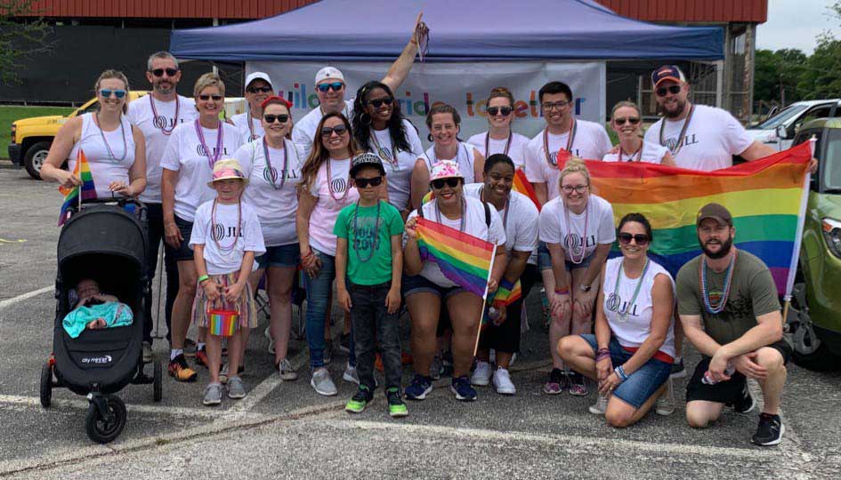 Group image of JLL employees in a local pride parade