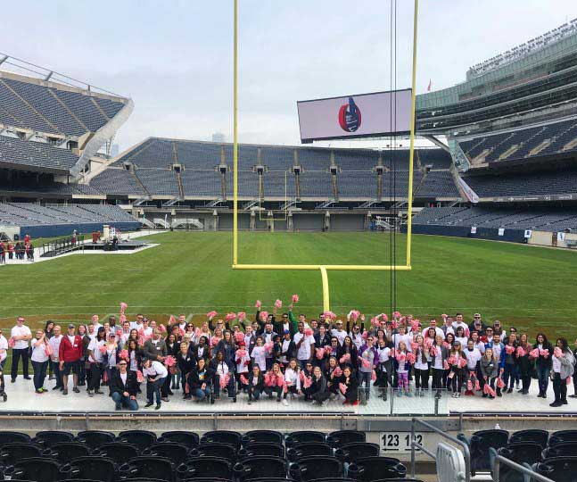 Group image of JLL employees in a stadium