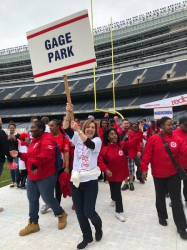 Image of JLL employee in a stadium holding a banner