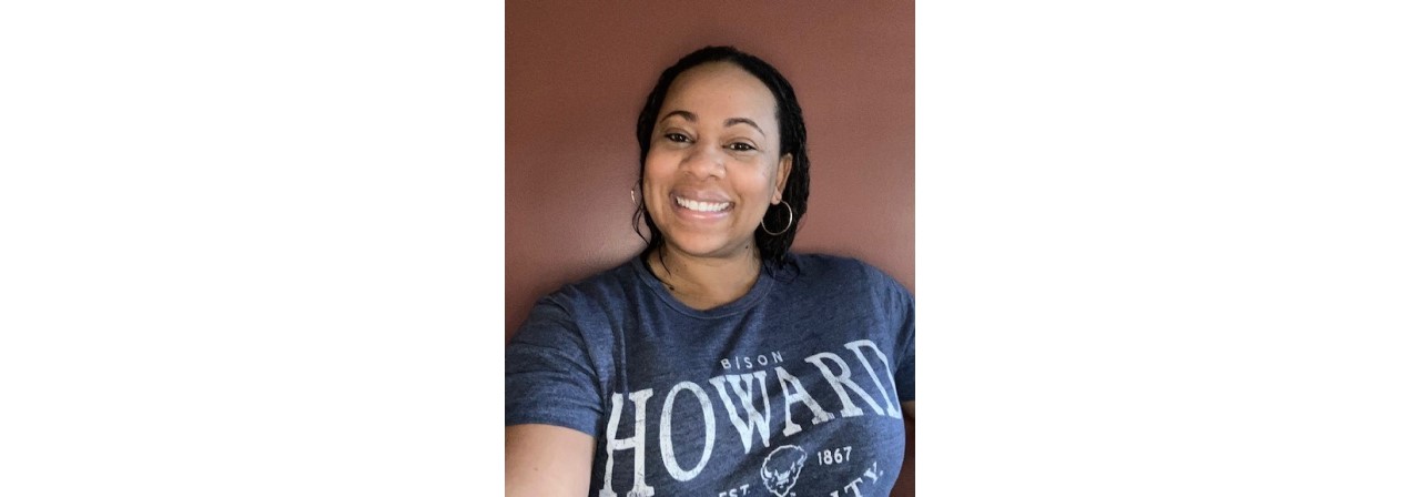 Malanda Worrell smiling while clicking a selfie in a casual tshirt (BISON Howard University 1867 is written on it)