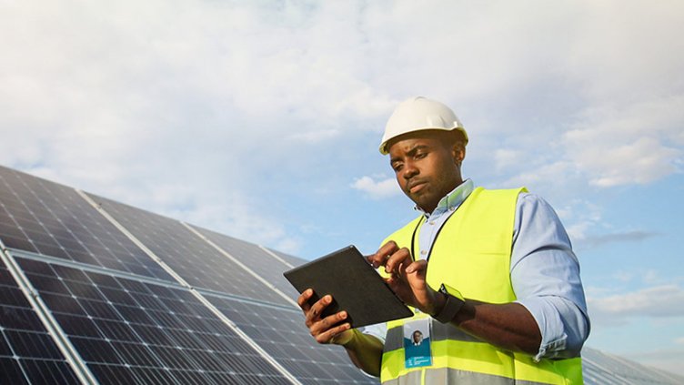 Engineer check the maintenance of solar panels by using digital tablet